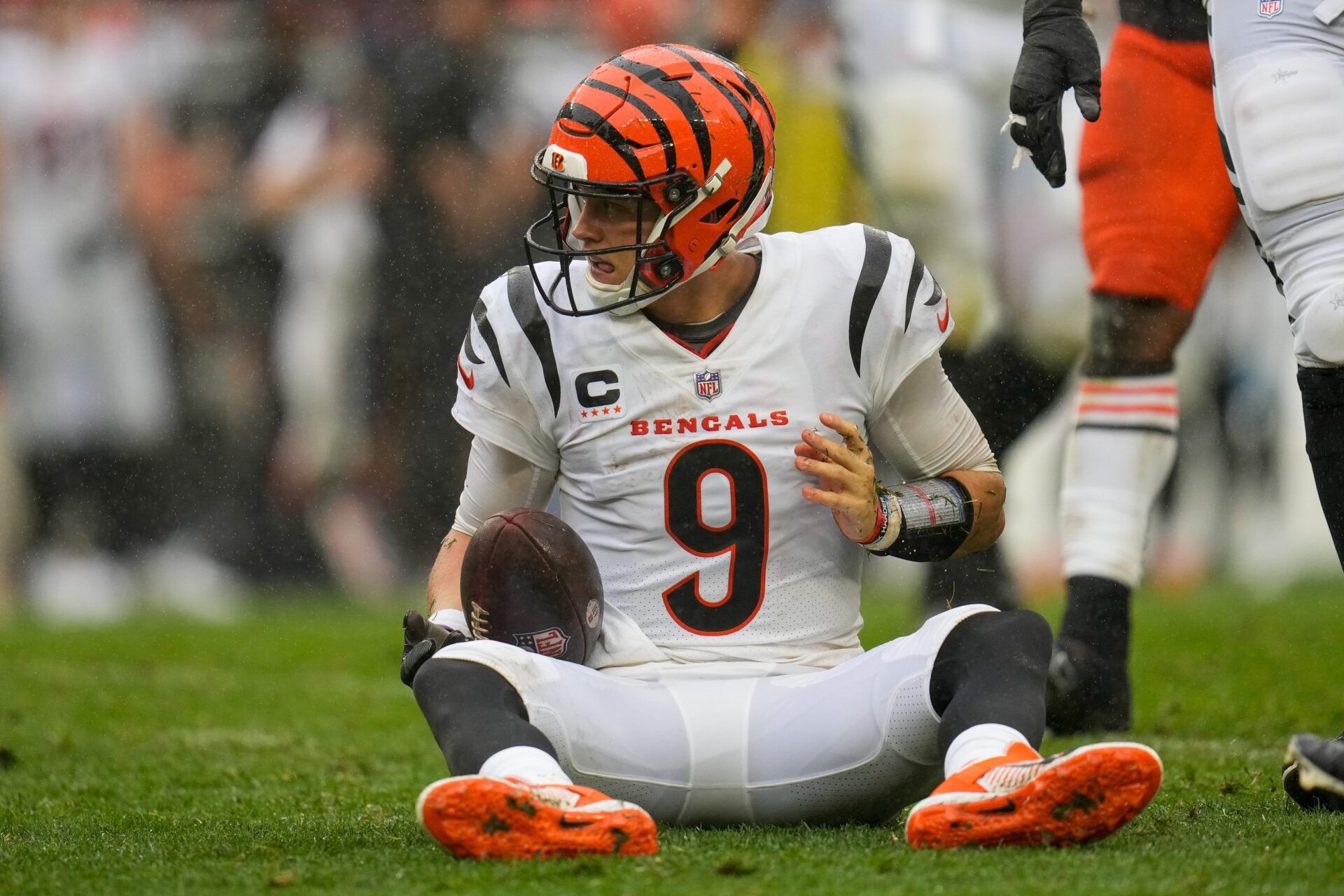 Joe Burrow (9) recovers on the ground after being sacked by Cleveland Browns defensive end Myles Garrett (95) in the fourth quarter of the NFL Week 1 game between the Cleveland Browns and the Cincinnati Bengals at FirstEnergy Stadium.