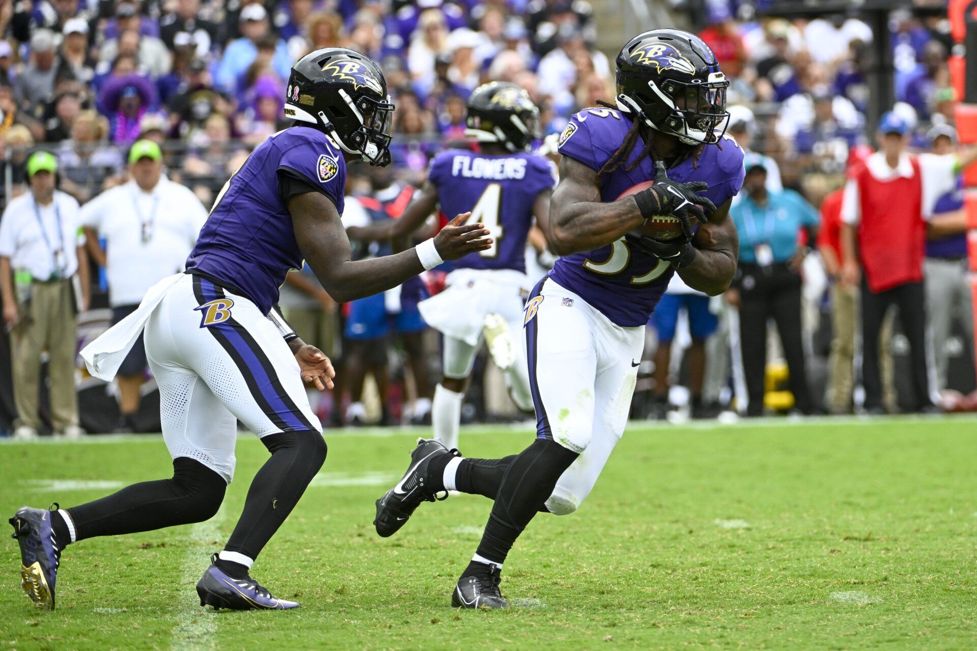 Gus Edwards (35) carries the ball against the Houston Texans during the second half at M&T Bank Stadium.