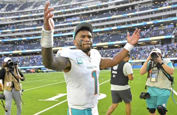 Tua Tagovailoa (1) celebrates as he leaves the field after defeating the Los Angeles Chargers 36-34 at SoFi Stadium.