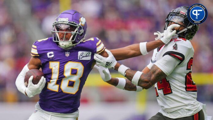 Minnesota Vikings WR Justin Jefferson (18) fights off a tackle against the Tampa Bay Buccaneers.