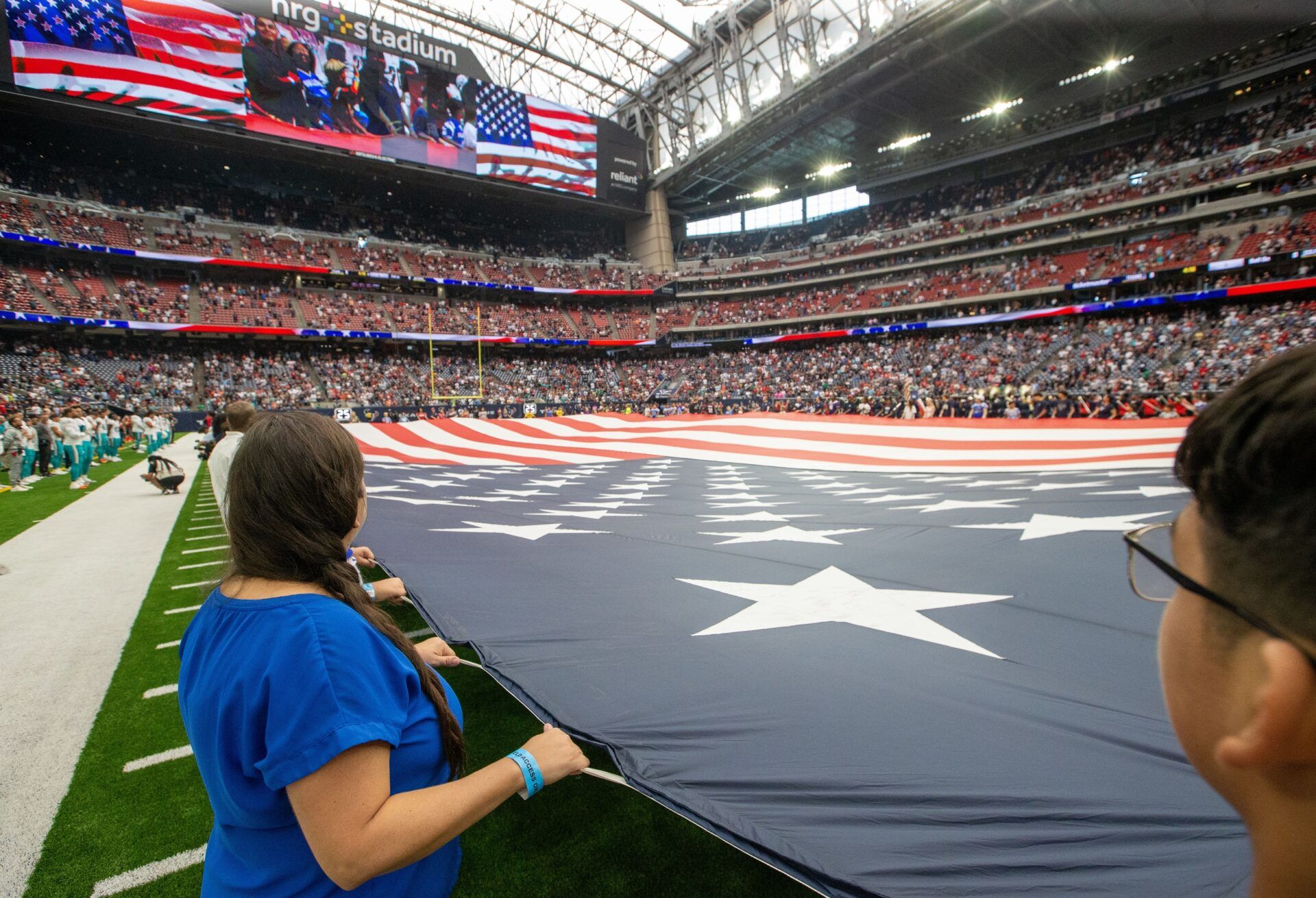 Fans wave a big flag for the national anthem before the Miami Dolphins played against the Houston Texans.