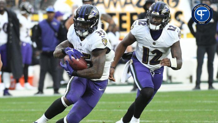 Baltimore Ravens running back Gus Edwards (35) after taking a handoff from quarterback Anthony Brown (12) while playing the Pittsburgh Steelers during the fourth quarter at Acrisure Stadium.