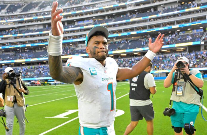 Miami Dolphins quarterback Tua Tagovailoa (1) celebrates as he leaves the field after defeating the Los Angeles Chargers 36-34 at SoFi Stadium.