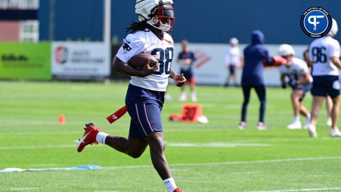 New England Patriots running back Rhamondre Stevenson (38) runs with the ball during training camp at Gillette Stadium.