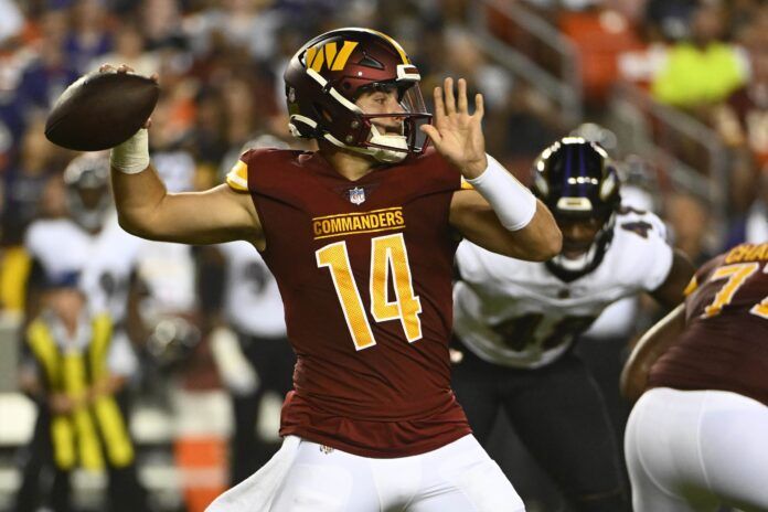 Sam Howell (14) attempts a pass against the Baltimore Ravens during the first half at FedExField.