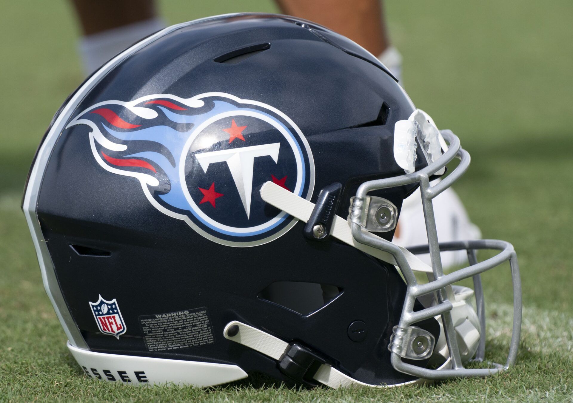 A Tennessee Titans helmet rests on the field during a training camp practice at Ascension Saint Thomas Sports Park.