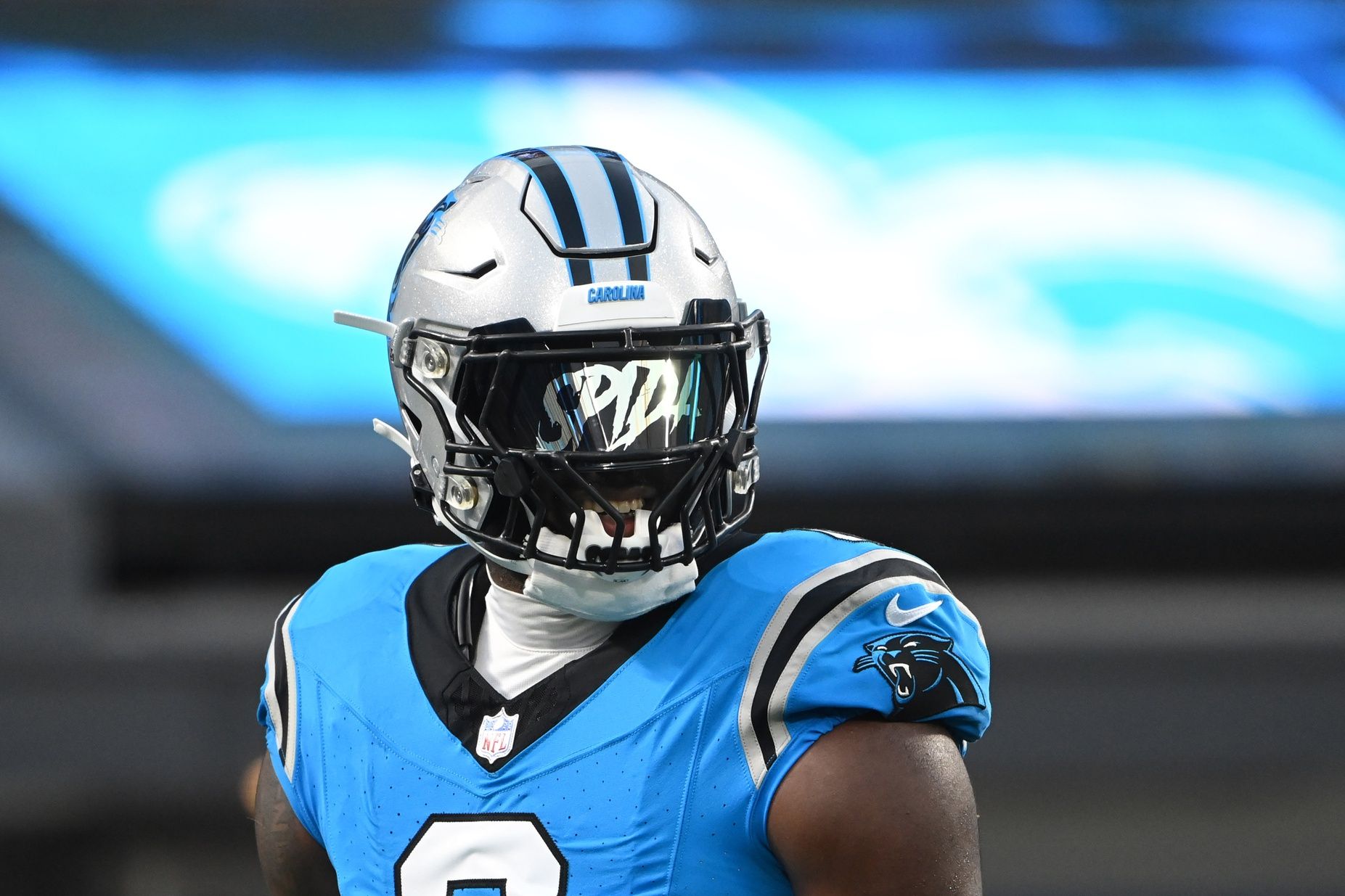 Brian Burns (0) warms up before the game at Bank of America Stadium.