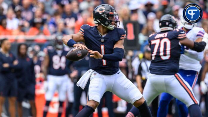 Justin Fields (1) drops back to pass against the Buffalo Bills during the first quarter at Soldier Field.