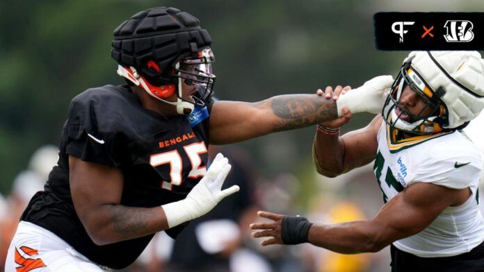 Orlando Brown Jr. (75), left, and Green Bay Packers linebacker Justin Hollins (47) compete during a joint practice between the Green Bay Packers and the Cincinnati Bengals.