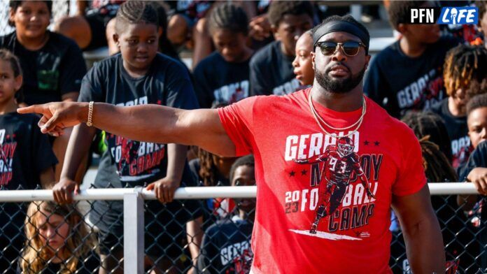 Gerald McCoy talks to children during a youth football camp hosted by McCoy and his Patricia Diane Foundation at Speegle Stadium in Oklahoma City.