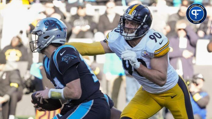 Carolina Panthers quarterback Sam Darnold (14) tries to elude Pittsburgh Steelers linebacker T.J. Watt (90) during the second half at Bank of America Stadium.