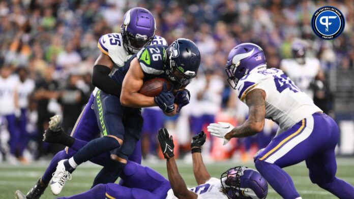 Minnesota Vikings safety Theo Jackson (25) and linebacker Ivan Pace Jr. (40) tackle Seattle Seahawks running back Zach Charbonnet (26) during the game at Lumen Field.