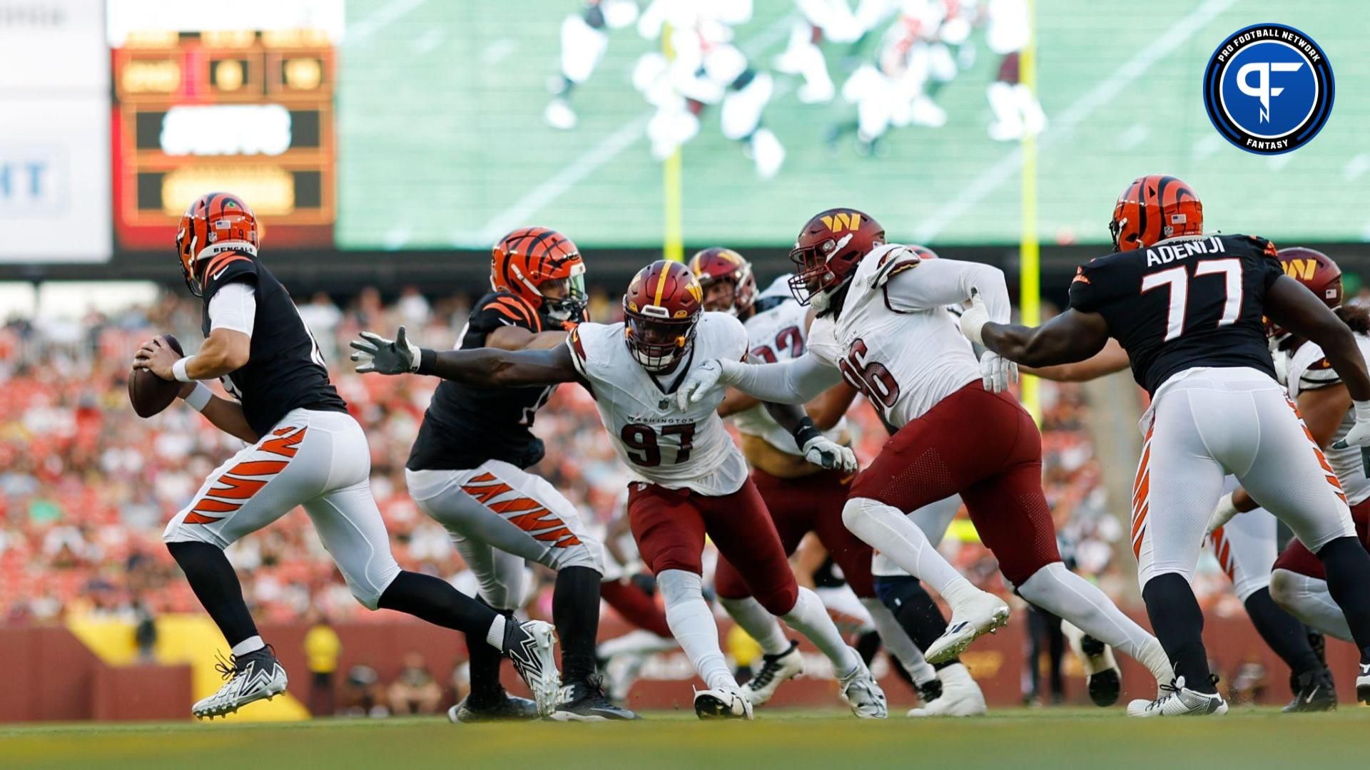 Cincinnati Bengals quarterback Trevor Siemian (19) scrambles from Washington Commanders defensive end Efe Obada (97) during the second quarter at FedExField.