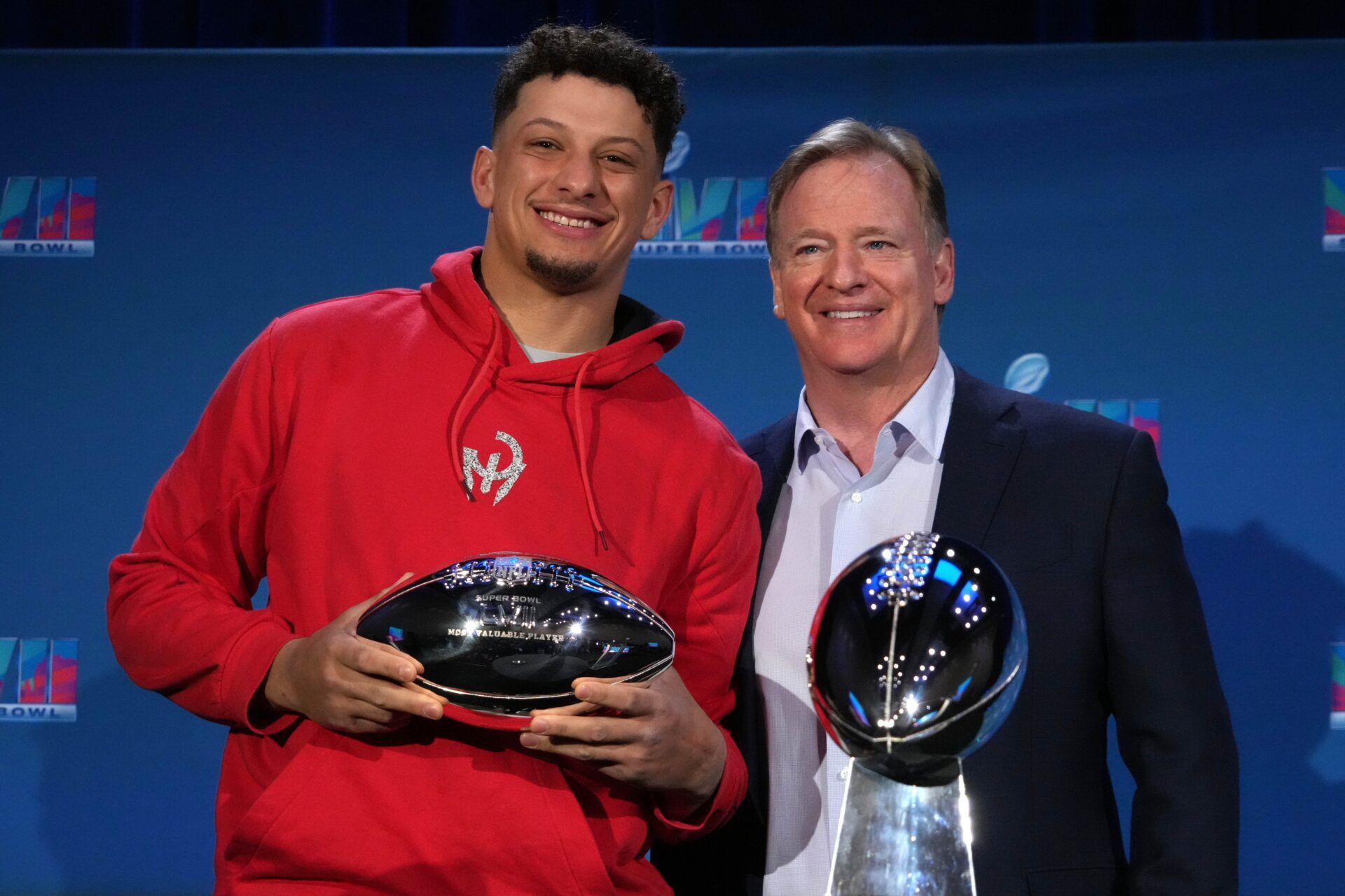 Kansas City Chiefs quarterback Patrick Mahomes (left) and NFL commissioner Roger Goodell pose with Vince Lombardi and most valuable player trophies during the Super Bowl 57 Winning Team Head Coach and MVP press conference at the Phoenix Convention Center.