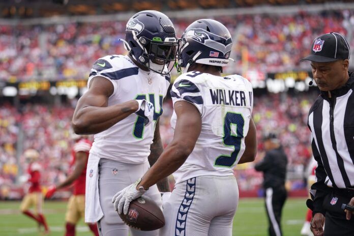 Seattle Seahawks wide receiver DK Metcalf (14) congratulates running back Kenneth Walker III (9) after his second quarter touchdown run during a wild card game against the San Francisco 49ers at Levi's Stadium.