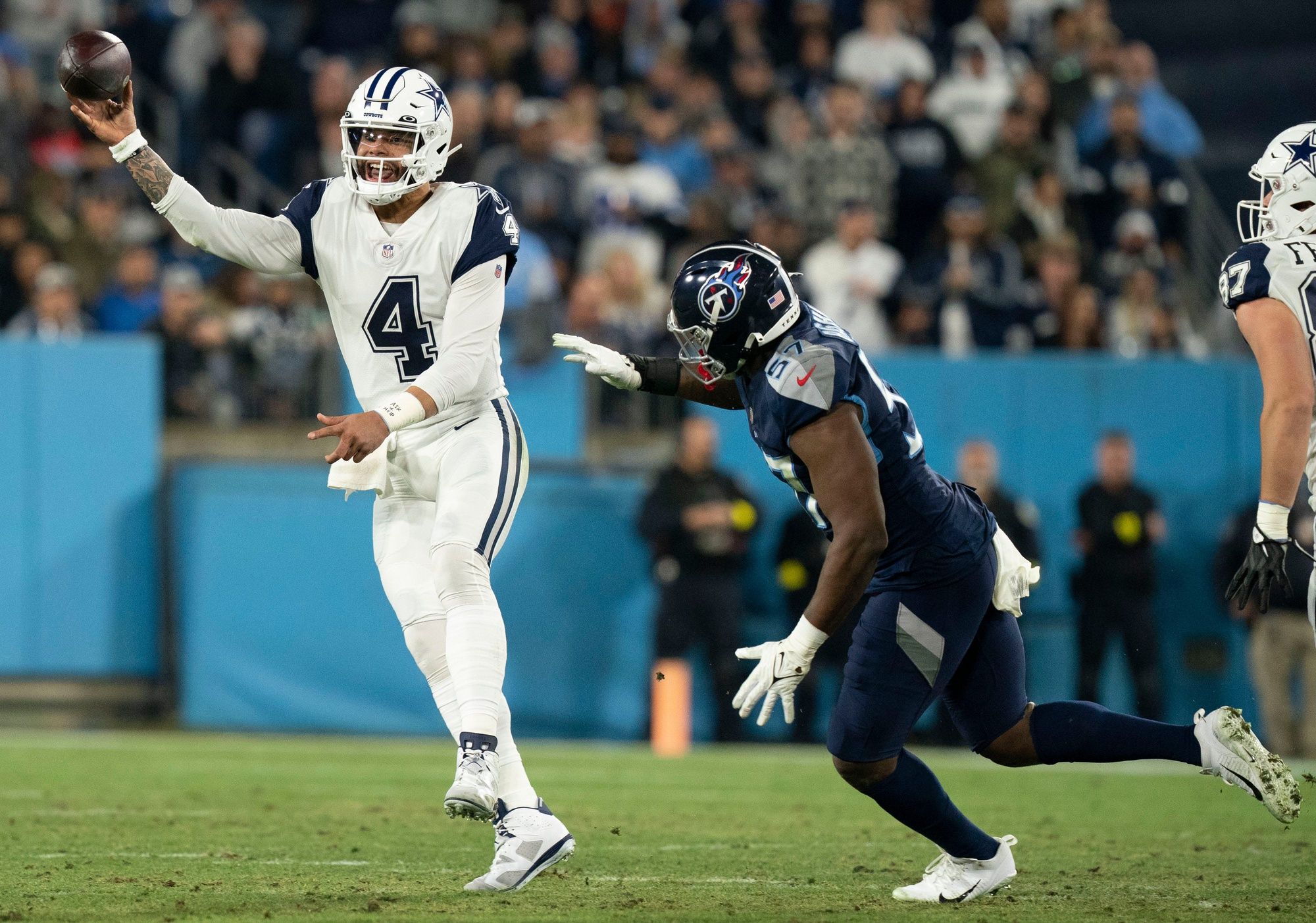 Dak Prescott (4) throws a pass as he is pressured by Tennessee Titans linebacker Tarell Basham (57).