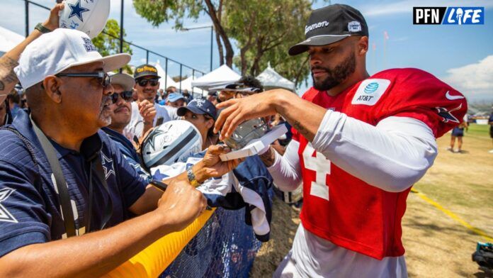 Dallas Cowboys QB Dak Prescott (4) signs autographs for fans.