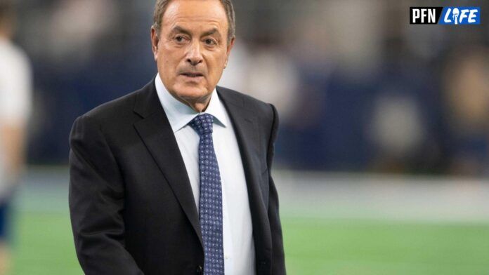 NFL Commentator Al Michaels crosses the field at the Cardinals vs. Cowboys game.