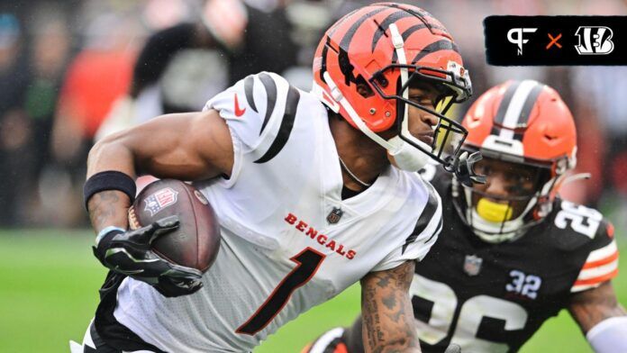 Cincinnati Bengals wide receiver Ja'Marr Chase (1) runs with the ball after a catch as Cleveland Browns safety Rodney McLeod (26) defends during the first half at Cleveland Browns Stadium.