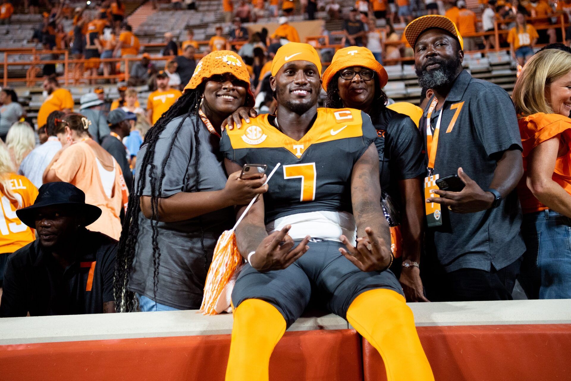 Joe Milton III (7) takes a photo with his family after a football game between Tennessee and Austin Peay at Neyland Stadium.