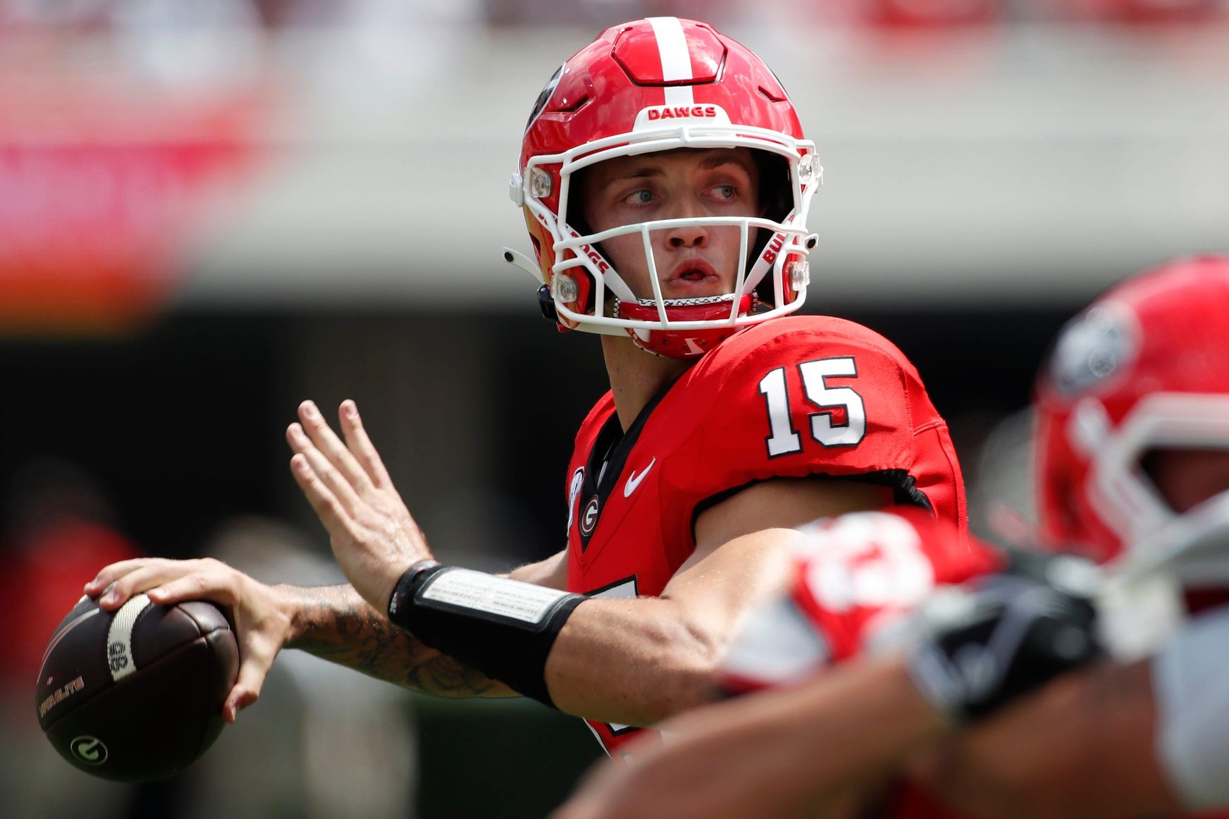 Carson Beck (15) looks to throw a pass during the first half of a NCAA college football game against Ball State.