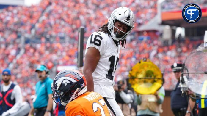 Las Vegas Raiders wide receiver Jakobi Meyers (16) reacts towards Denver Broncos cornerback Damarri Mathis (27) following his touchdown reception in the first quarter at Empower Field at Mile High.