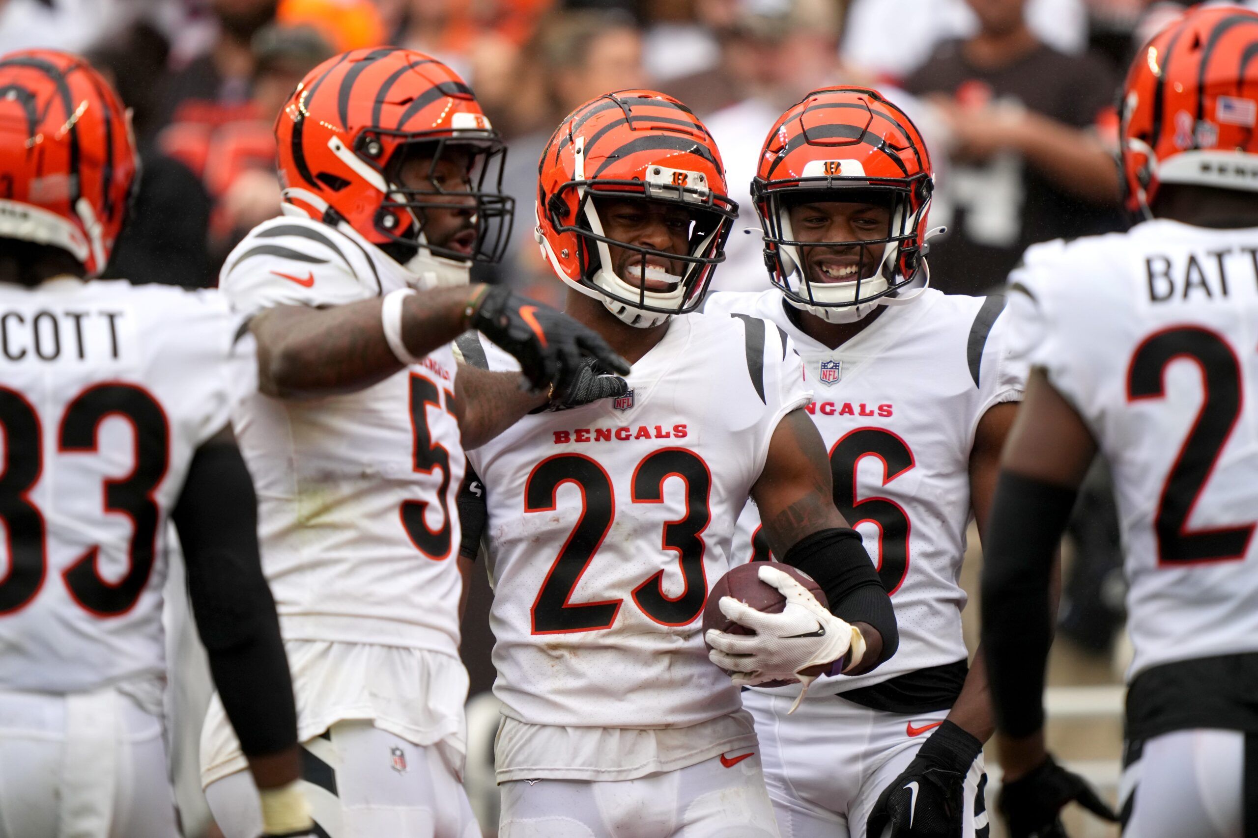 Dax Hill (23), center, is congratulated by Cincinnati Bengals linebacker Germaine Pratt (57), left, and Cincinnati Bengals safety Tycen Anderson (26), right, after interesting a pass in the third quarter of an NFL football game between the Cincinnati Bengals and Cleveland Browns, Sunday, Sept. 10, 2023, at Cleveland Browns Stadium in Cleveland.