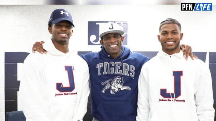 Deion Sanders smiling for pictures with two of his children during his tenure as the Jackson State head coach.