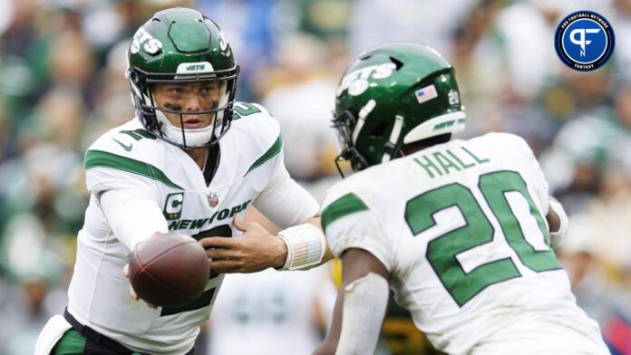 New York Jets quarterback Zach Wilson (2) hands the football off to running back Breece Hall (20) during the fourth quarter against the Green Bay Packers at Lambeau Field.