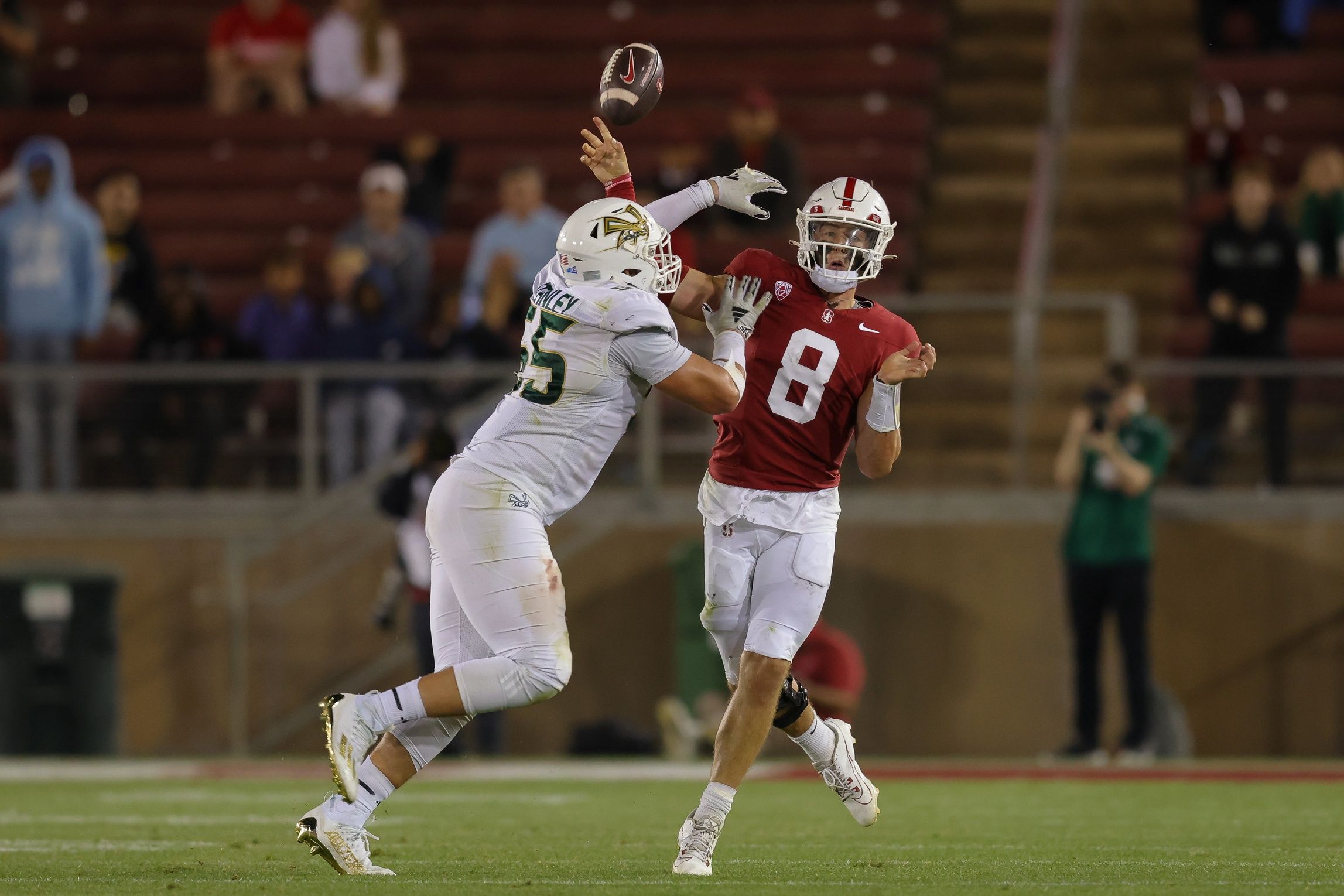 Justin Lamson (8) is hit by Sacramento State Hornets defensive lineman Jett Stanley (55) during the fourth quarter at Stanford Stadium.