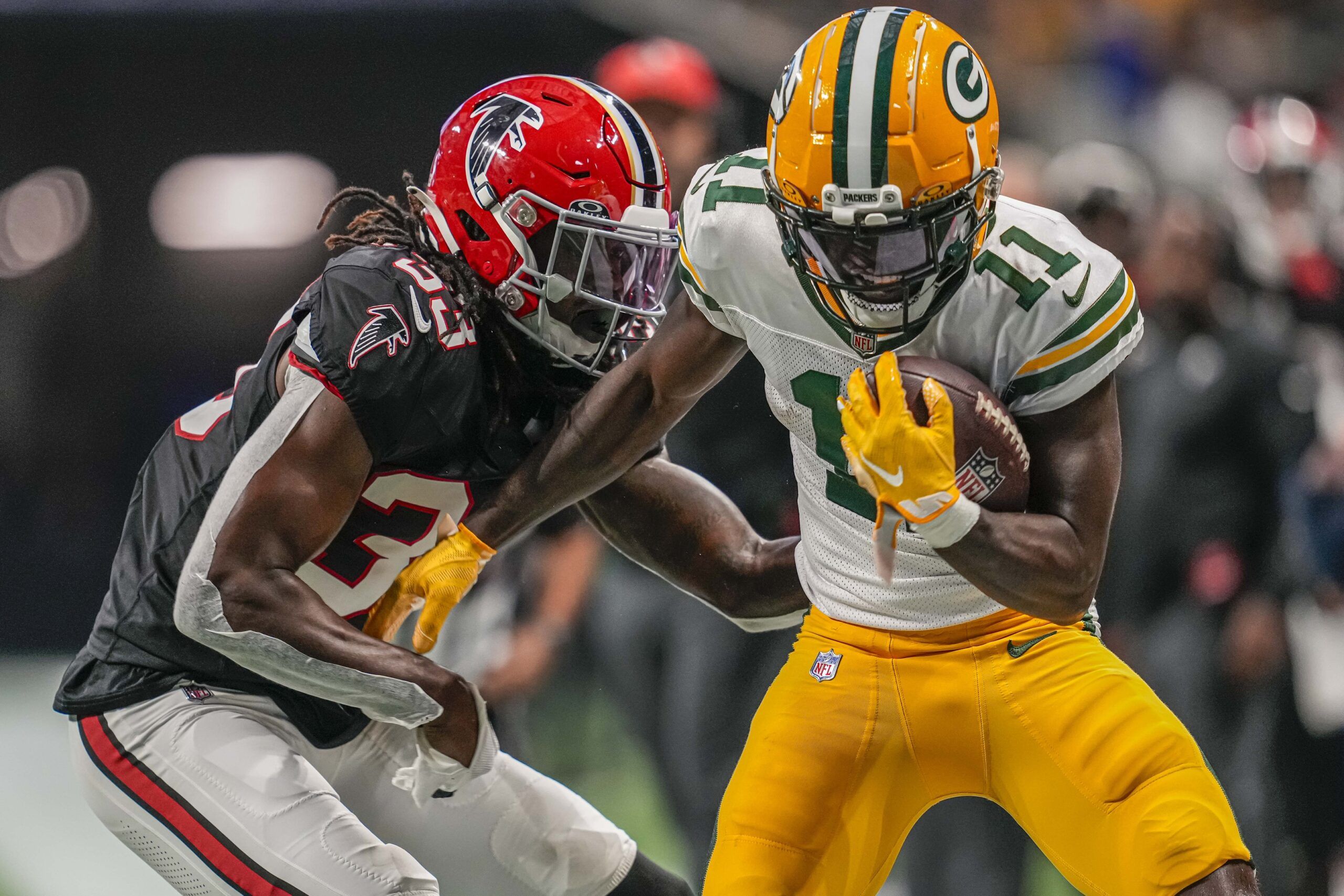 Jayden Reed (11) runs against Atlanta Falcons cornerback Tre Flowers (33) during the second half at Mercedes-Benz Stadium.