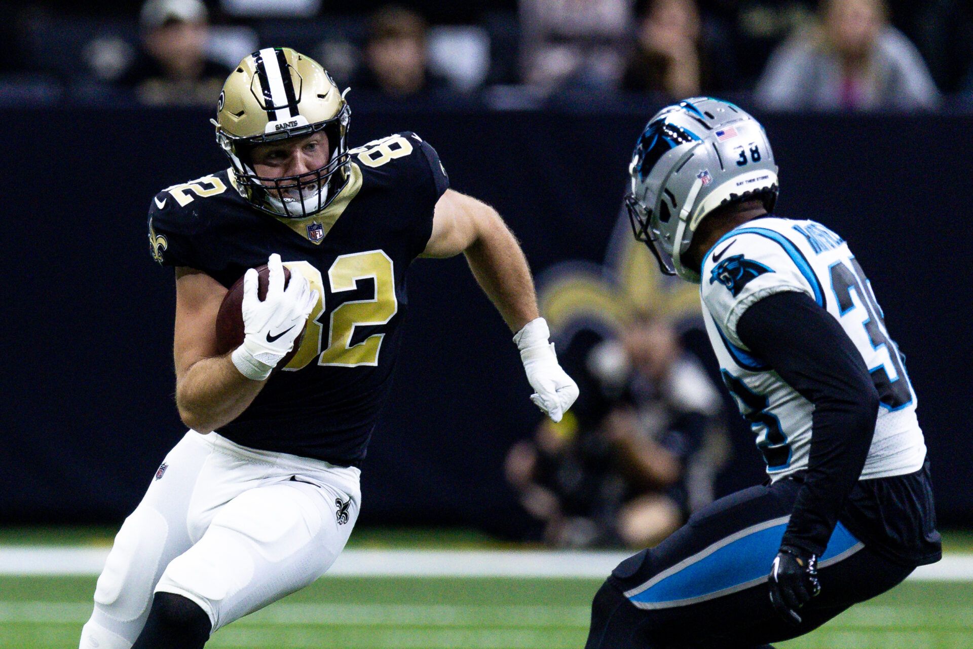 Carolina Panthers cornerback Myles Hartsfield (38) tackles New Orleans Saints tight end Adam Trautman (82) during the second half at Caesars Superdome.