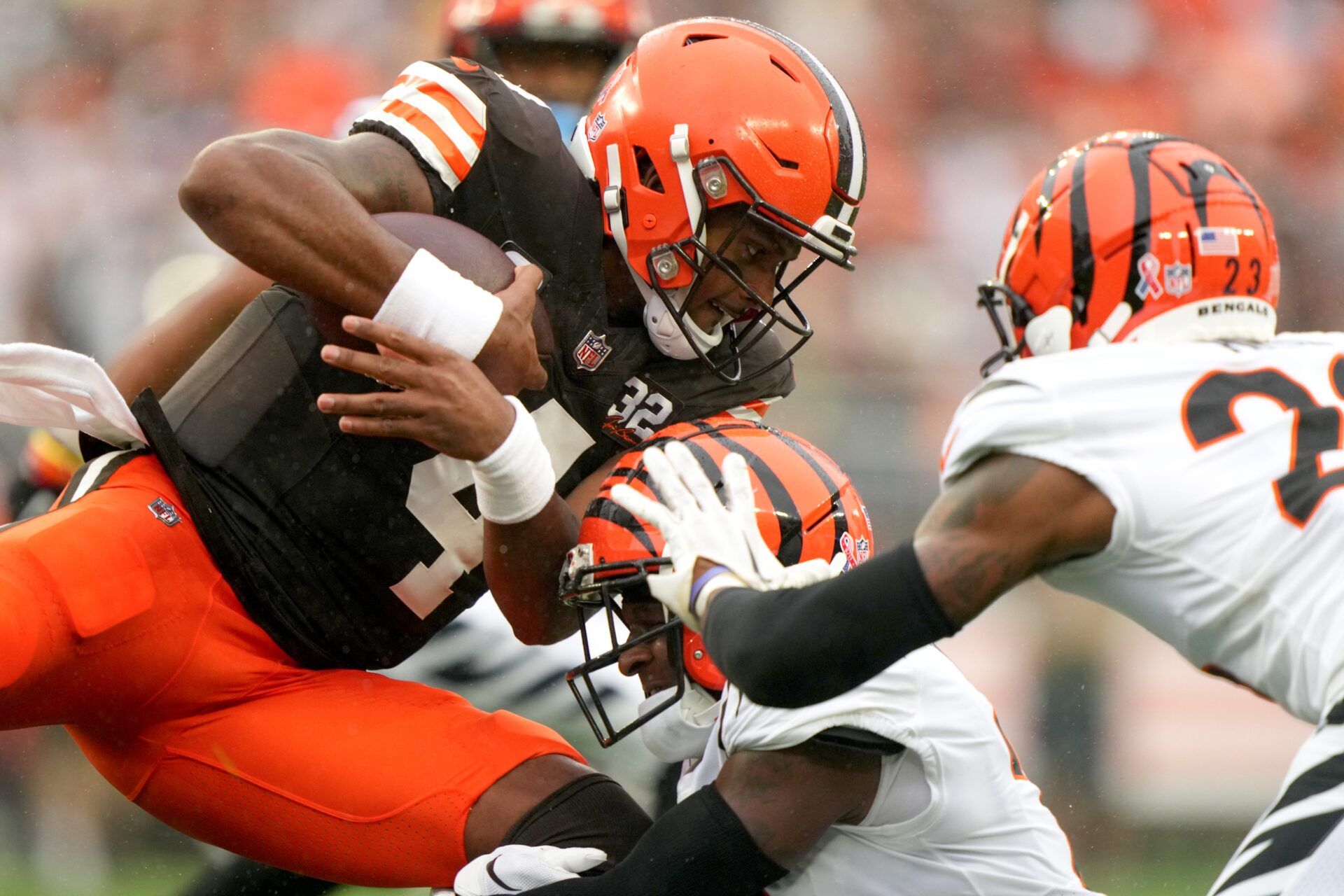 Cleveland Browns quarterback Deshaun Watson (4) runs for a first down as Cincinnati Bengals cornerback Mike Hilton (21) makes the tackle in the first quarter of an NFL football game between the Cincinnati Bengals and Cleveland Browns