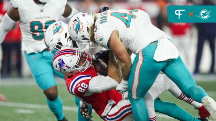 Andrew Van Ginkel (43) tackles New England Patriots tight end Mike Gesicki (88) during the first half at Gillette Stadium.