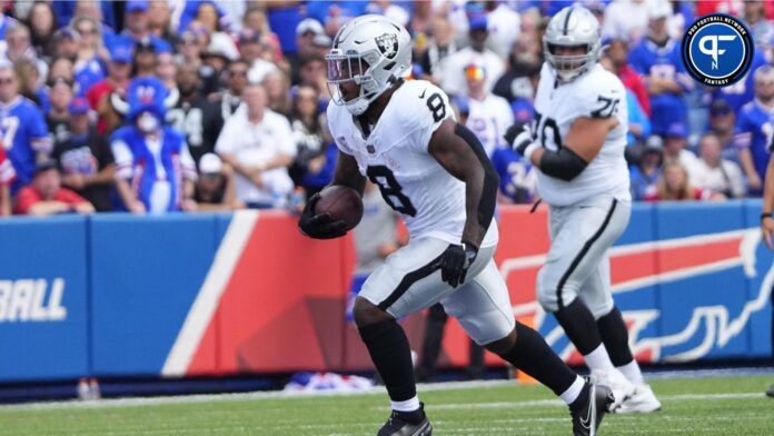 Josh Jacobs (8) runs with the ball against the Buffalo Bills during the first half at Highmark Stadium.