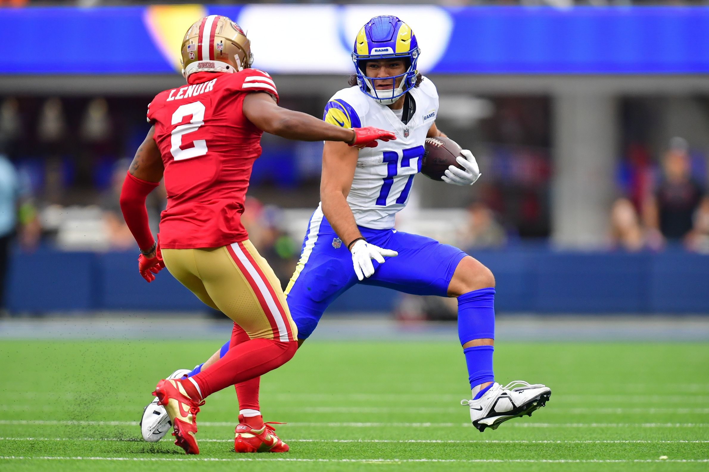 Puka Nacua (17) runs the ball against San Francisco 49ers cornerback Deommodore Lenoir (2) during the first half at SoFi Stadium.