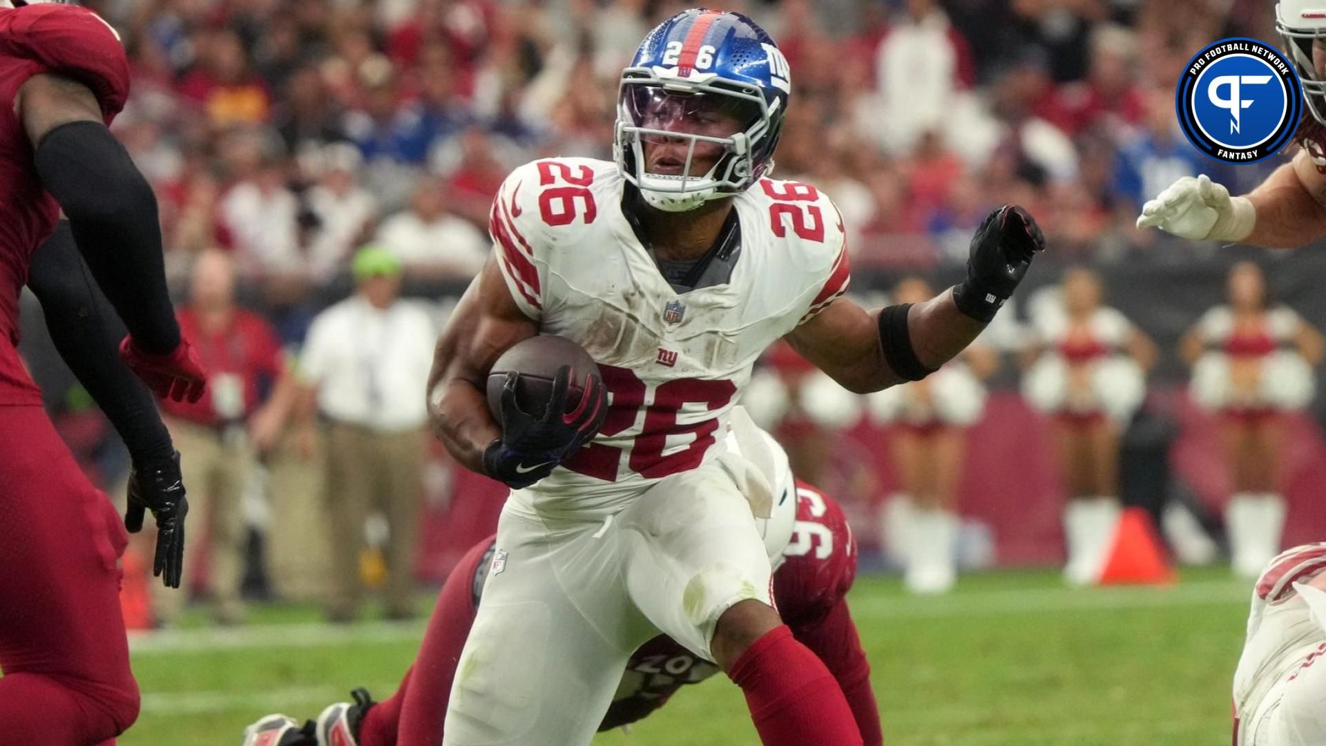 New York Giants running back Saquon Barkley (26) runs the ball against the Arizona Cardinals at State Farm Stadium in Glendale on Sept. 17, 2023.