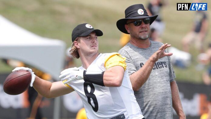 Kenny Pickett (8) passes the ball as offensive coordinator Matt Canada (right) instructs in drills during training camp at Saint Vincent College.