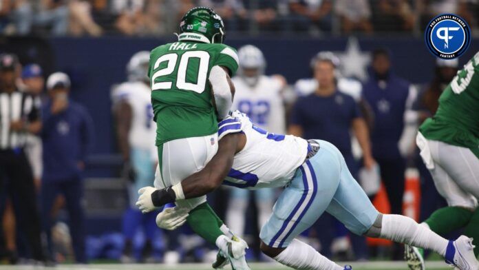 Breece Hall (20) is tackled by Dallas Cowboys defensive end DeMarcus Lawrence (90) in the first quarter at AT&T Stadium.