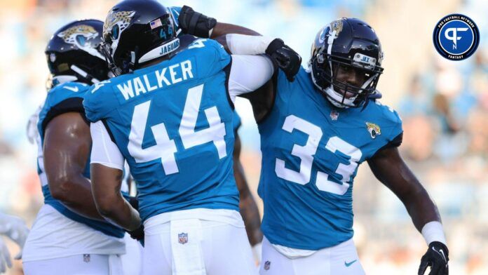 Travon Walker (44) greets linebacker Devin Lloyd (33) before the game of a preseason matchup Saturday, Aug. 26, 2023 at EverBank Stadium in Jacksonville, Fla.