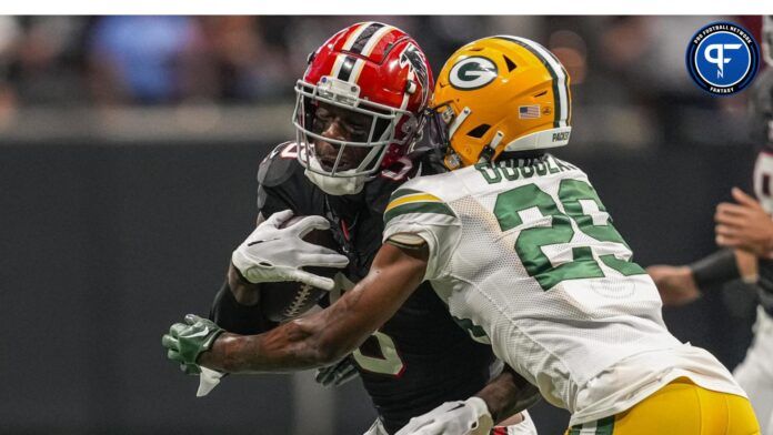 Atlanta Falcons tight end Kyle Pitts (8) is hit by Green Bay Packers cornerback Rasul Douglas (29) after making a catch during the first half at Mercedes-Benz Stadium.