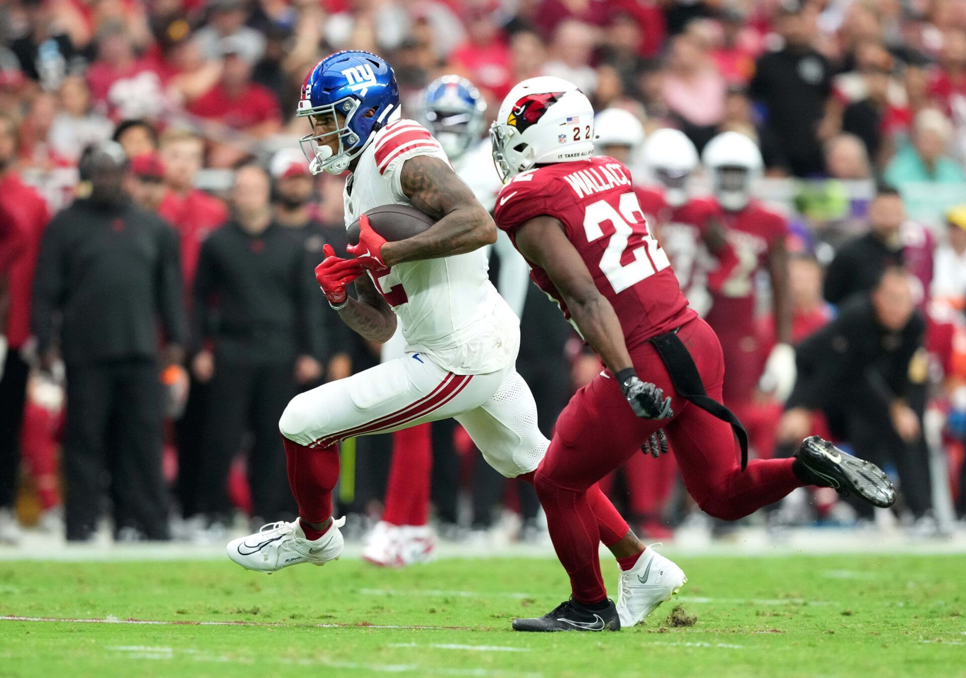 Darren Waller (12) runs with the ball against the Arizona Cardinals during the second half at State Farm Stadium.