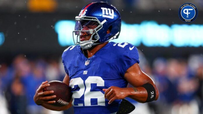 New York Giants running back Saquon Barkley (26) runs with the ball during warmups for their game against the Dallas Cowboys at MetLife Stadium.