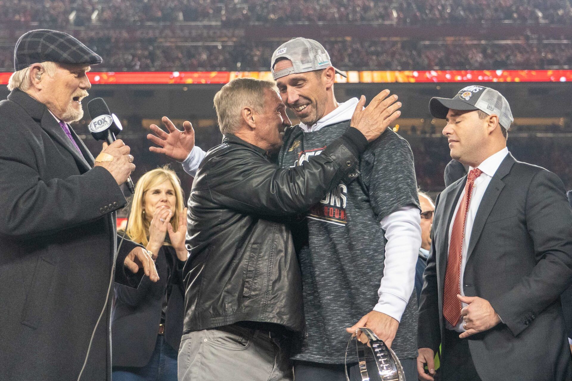 Mike Shanahan hugs his son, Kyle, after he won the NFC Championship Game.