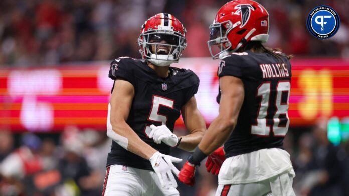 Atlanta Falcons wide receiver Mack Hollins (18) reacts with wide receiver Drake London (5) after a catch against the Green Bay Packers in the second half at Mercedes-Benz Stadium.