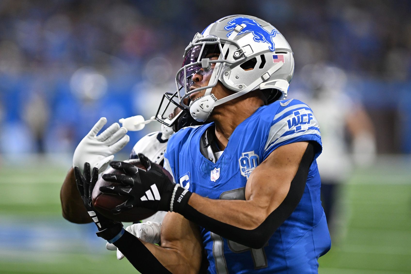 Amon-Ra St. Brown (14) catches a pass against the Seattle Seahawks in the second quarter at Ford Field.