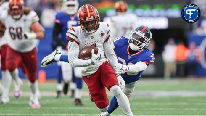 Jahan Dotson (1) breaks a tackle by New York Giants cornerback Zyon Gilbert (38) during a touchdown reception during the second half at MetLife Stadium.