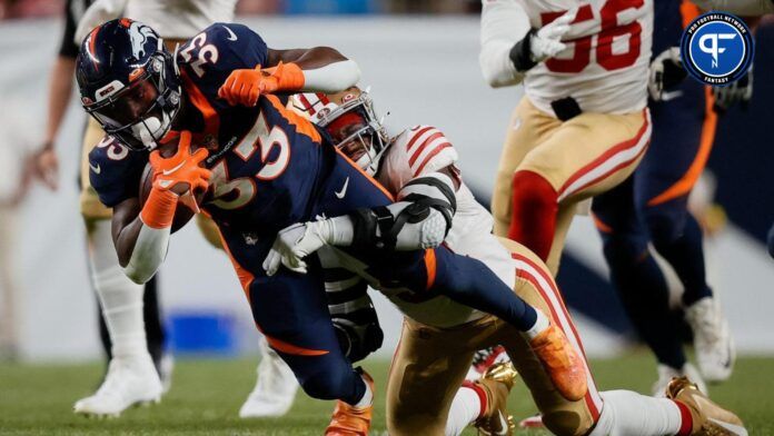 Denver Broncos running back Javonte Williams gets tackled against the San Francisco 49ers.