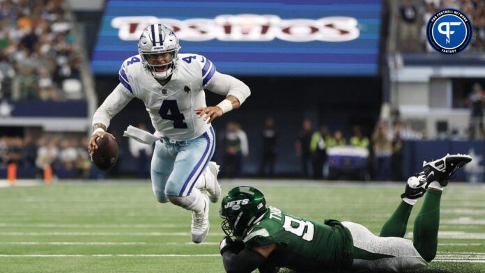 Dallas Cowboys quarterback Dak Prescott falling after a tackle attempt from New York Jets defensive lineman Solomon Thomas.