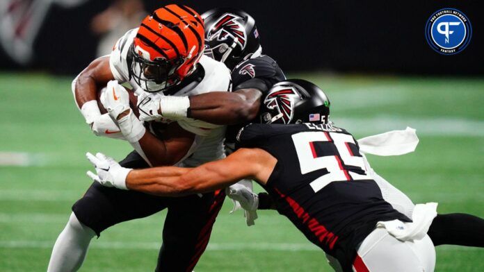 Cincinnati Bengals running back Chris Evans (25) carries the ball against Atlanta Falcons linebacker Kaden Elliss (55) during the first quarter at Mercedes-Benz Stadium.